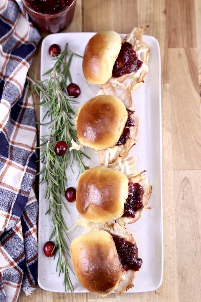 Overhead view of platter of 4 turkey sliders with cranberry bbq sauce