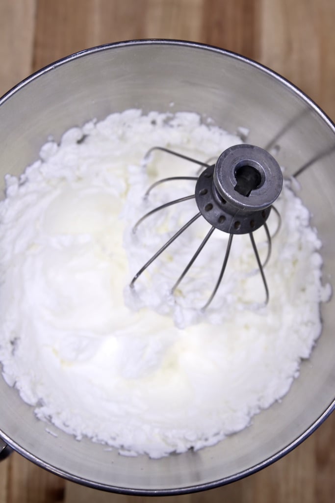 Whipped cream in a bowl with the whisk