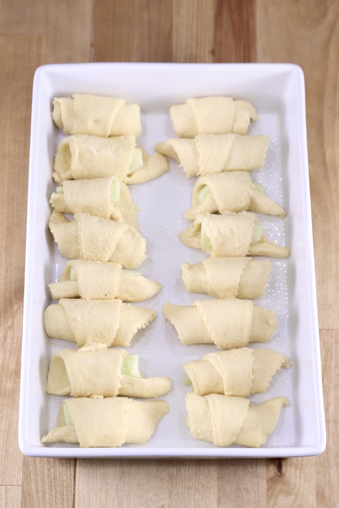 Crescent wrapped apples in a baking pan