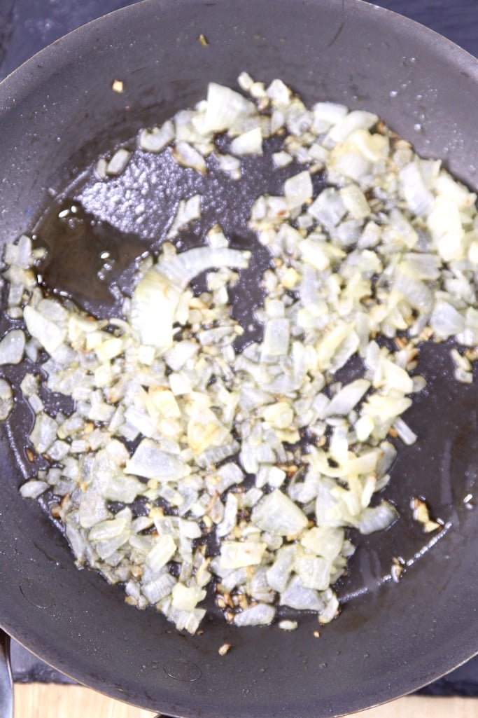 Cooked diced onions and garlic in a skillet
