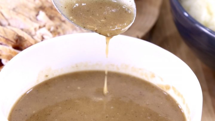 Brown Gravy in bowl with ladle dipping