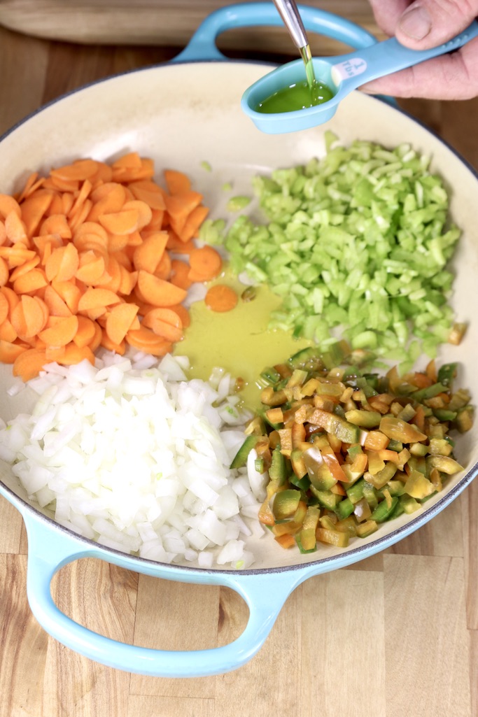 Diced carrots, celery, onions and bell peppers with olive oil in a pan