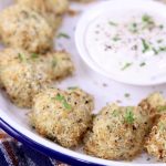 Breaded Mushrooms on a platter with ranch dressing in the center