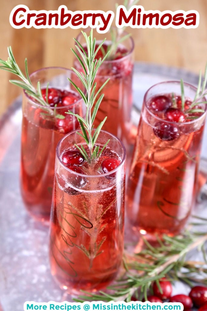 Cranberry Mimosas on a tray with rosemary garnish with text overlay