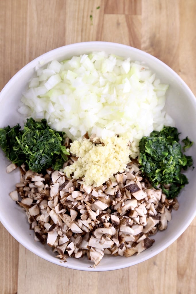 Bowl of diced onions, mushrooms, garlic and spinach