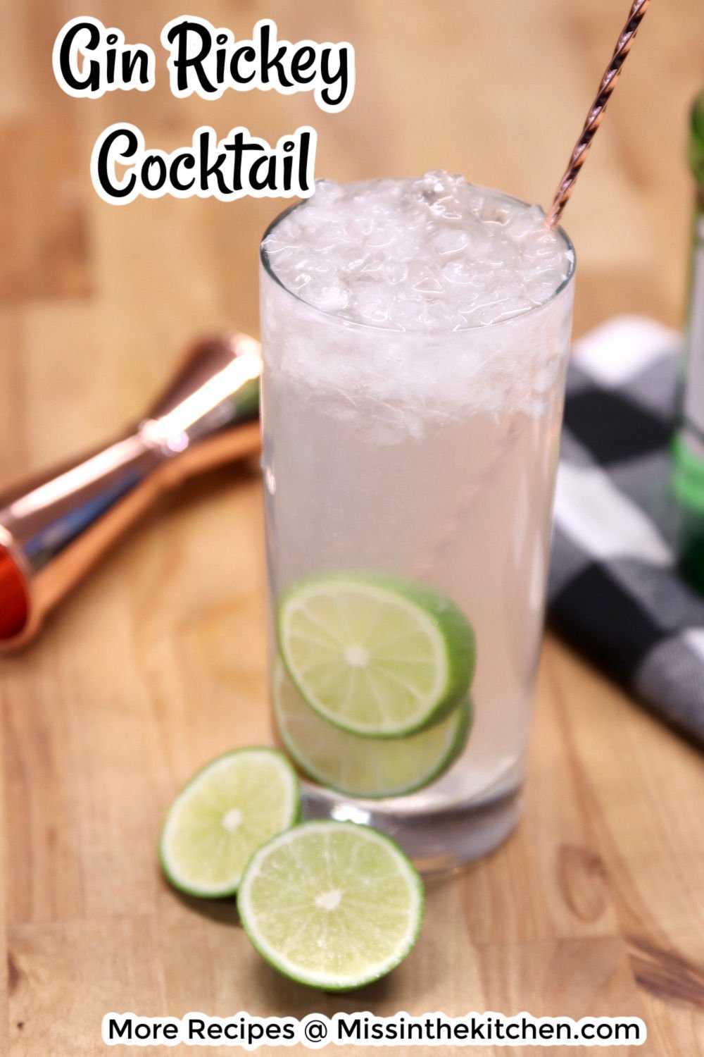 Gin Rickey Cocktail in a collins glass with lime garnish and a cocktail stirring spoon - text overlay