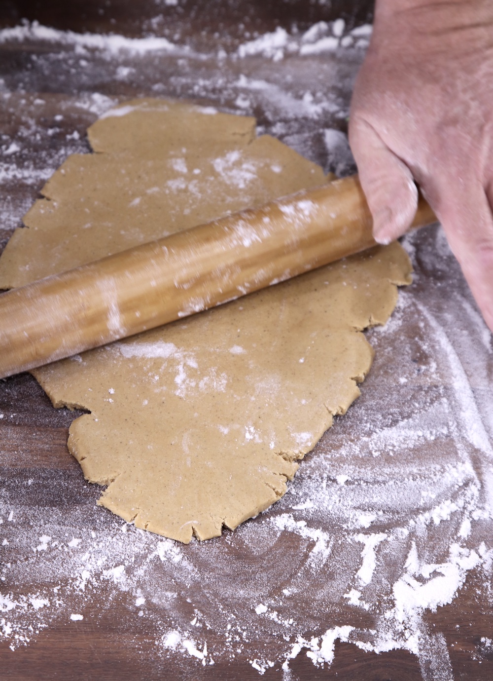 Rolling out gingerbread cookie dough with a rolling pin