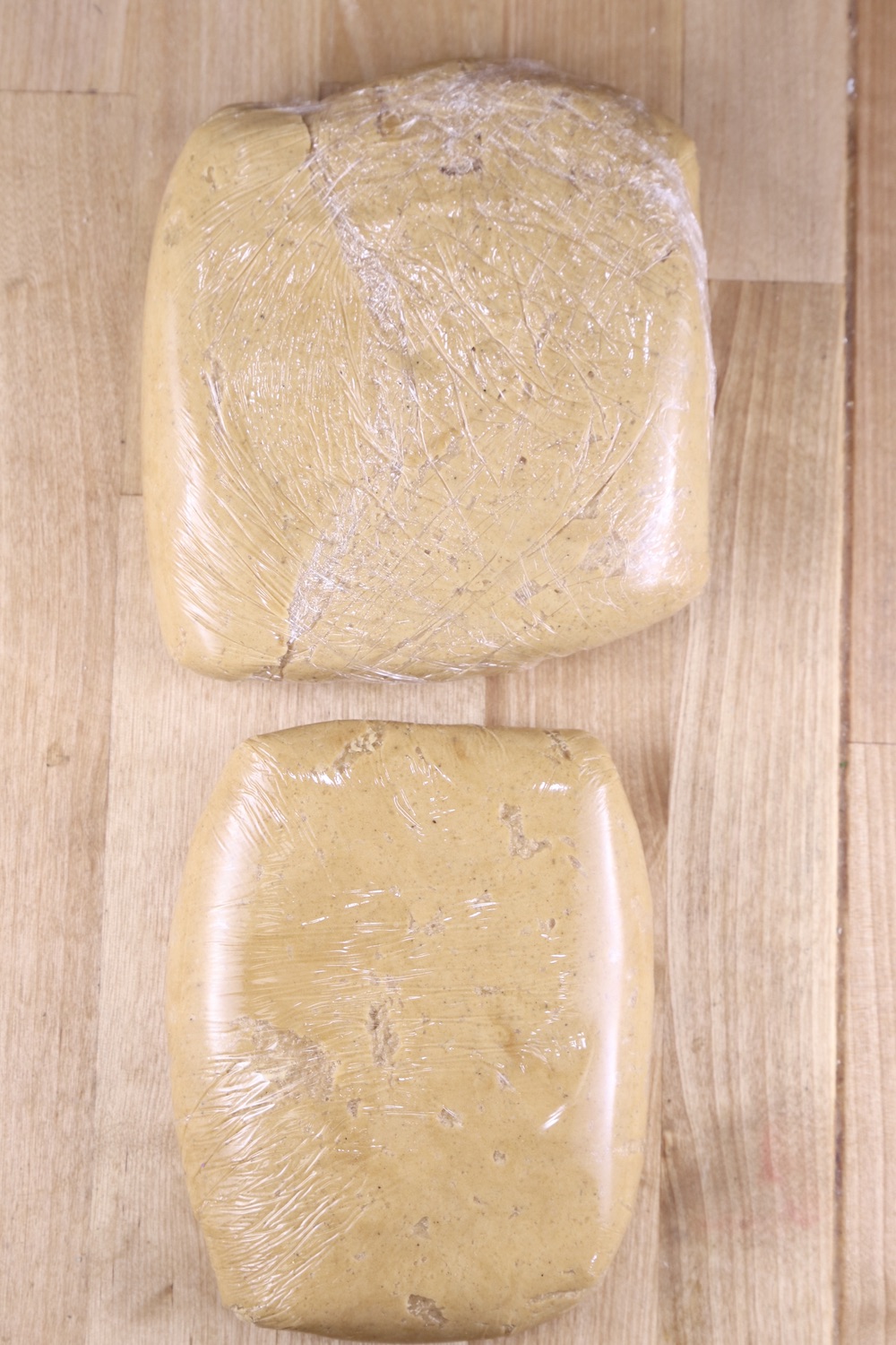 Gingerbread Cookie Dough in 2 squares wrapped in plastic wrap.