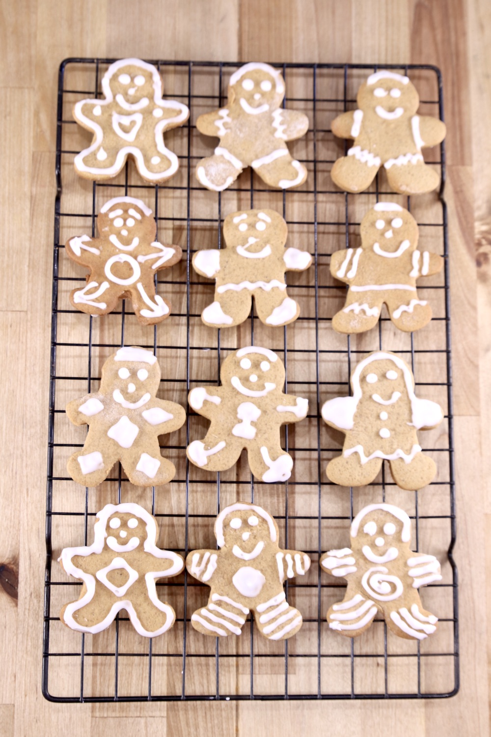 Decorated gingerbread men cookies on a wire rack