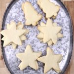 Cut out sugar cookies on a platter with Christmas shapes - trees, stars