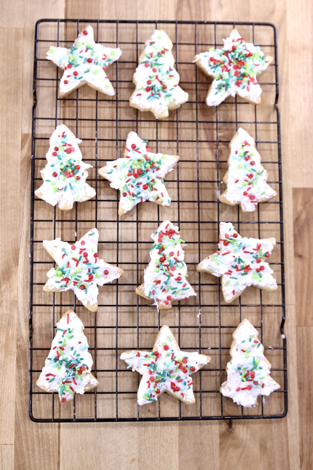Sugar Cookies with icing and sprinkles on a wire rack