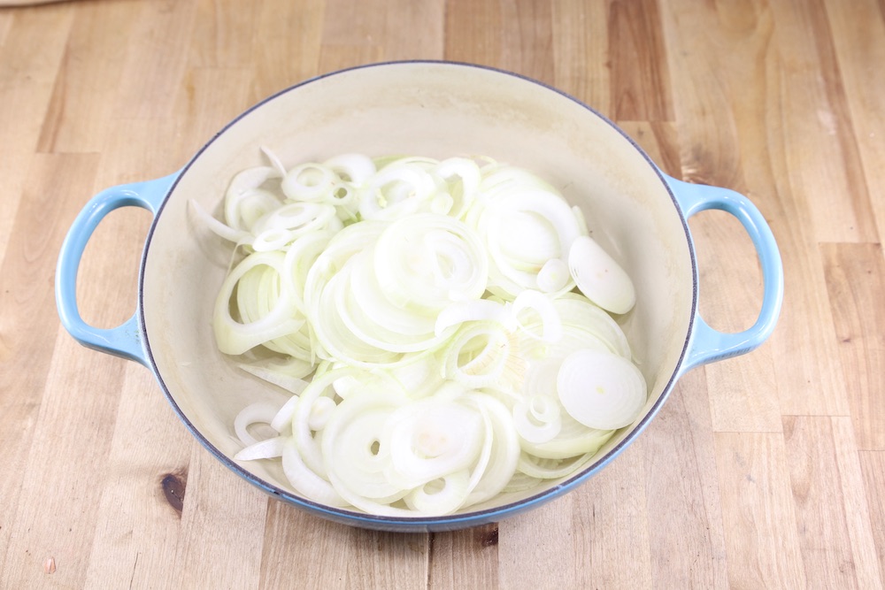 Sliced onions in a large pan