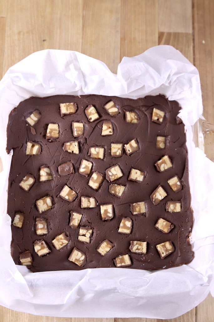 Chilled snickers fudge with parchment paper