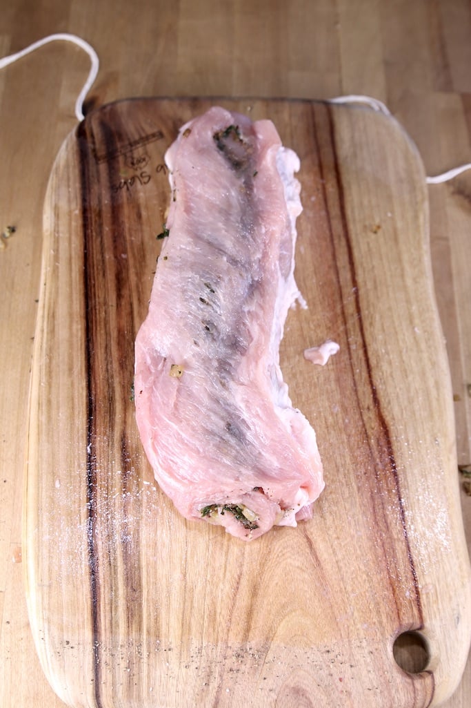 Rolled up stuffed pork loin on cutting board