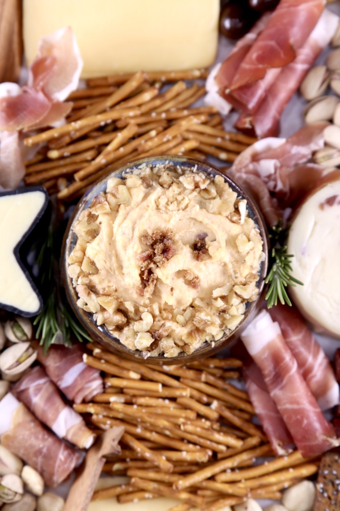 Charcuterie board with beer cheese dip, pretzels, cheese and meats