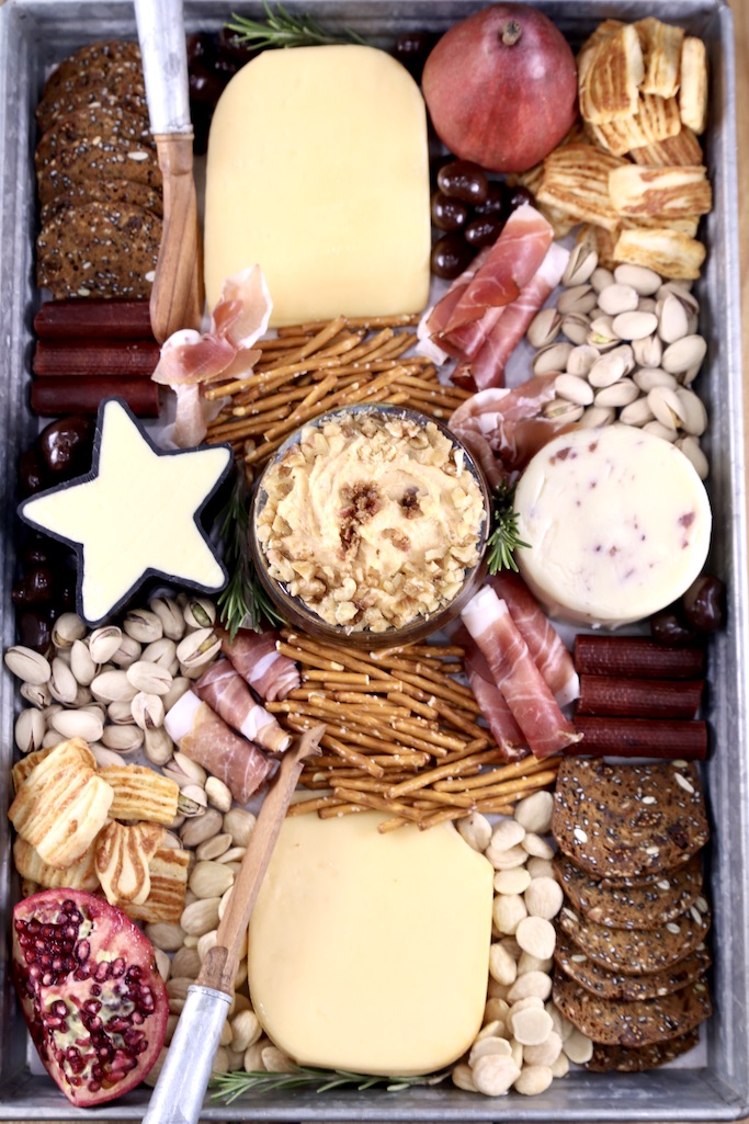 Charcuterie board with Bacon beer cheese dip, cheese, nuts and crackers