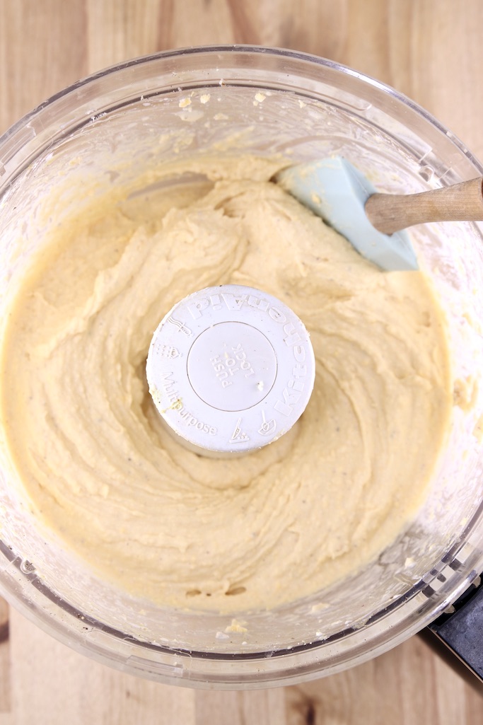 Food processor bowl with beer cheese dip and a spatula
