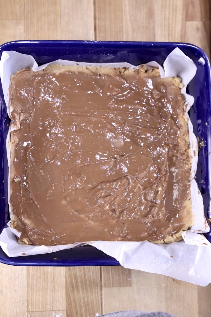 Peanut Butter Cup Fudge with melted chocolate on top - in a blue baking dish