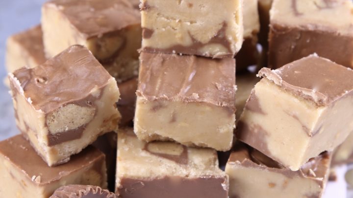 Peanut Butter Cup Fudge stacked on a polka dot baking sheet
