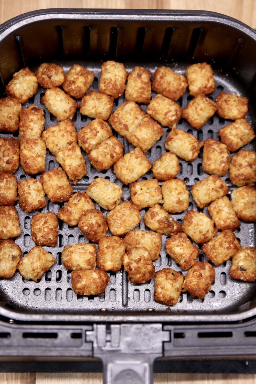 Air Fryer with cooked tater tots