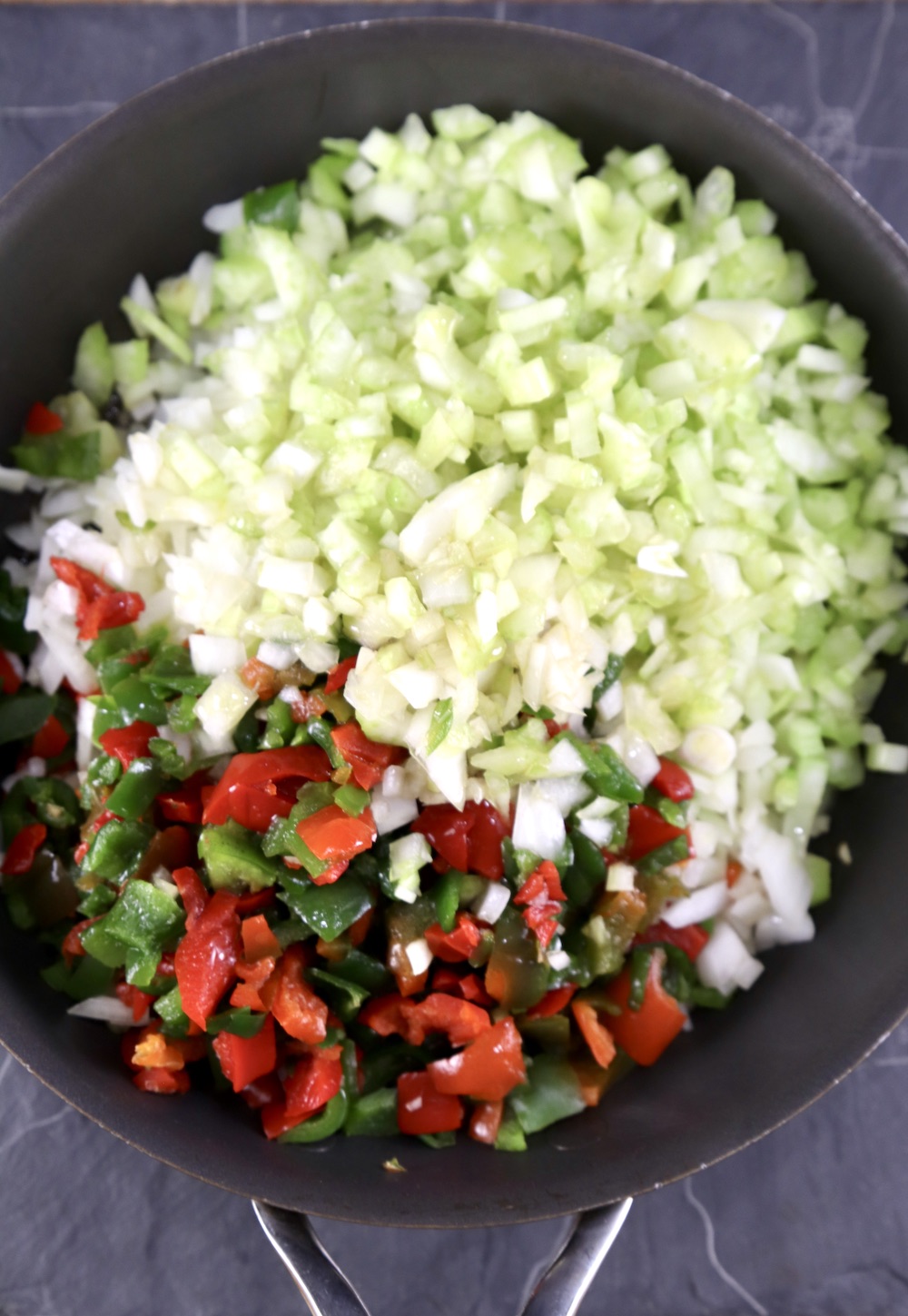 Celery, onions and bell peppers chopped in a skillet