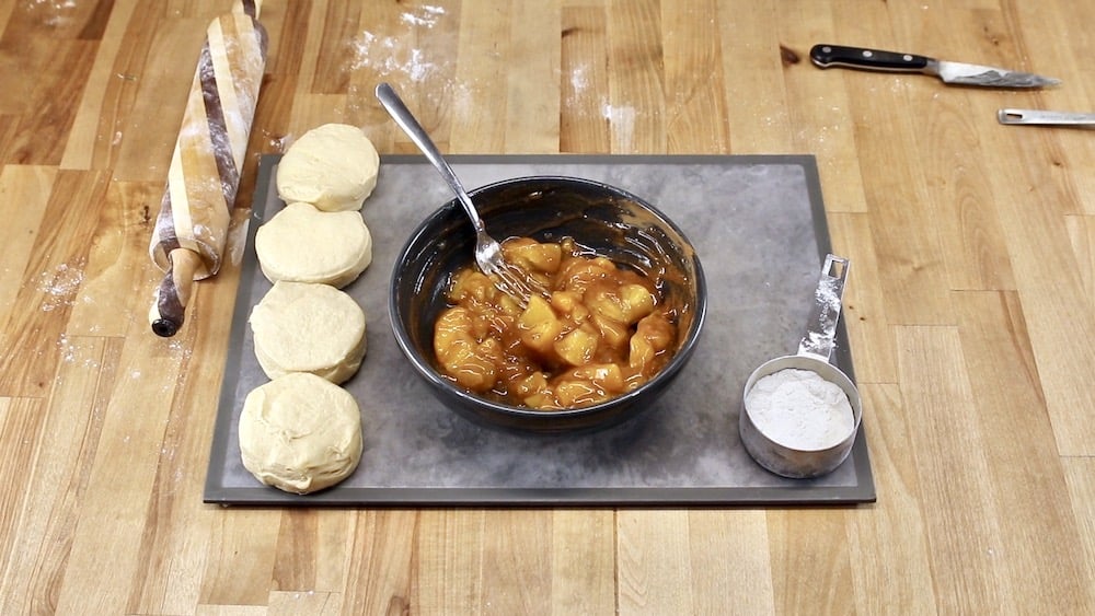 bowl of peach pie filling with can biscuits for air fryer dessert