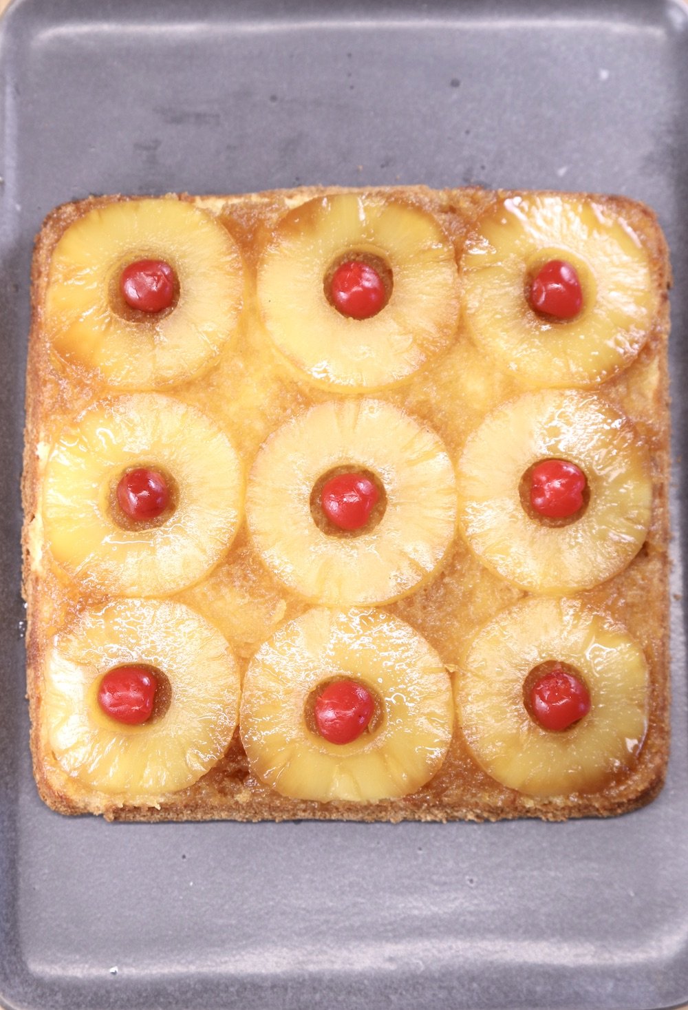 Pineapple Upside Down Cake - square with pineapple rings and cherries in the center