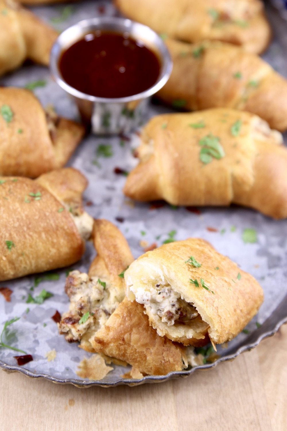 Sausage Cream Cheese Crescents with one broke in two on a platter