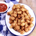 Tater Tots on a platter, cup of ketcup