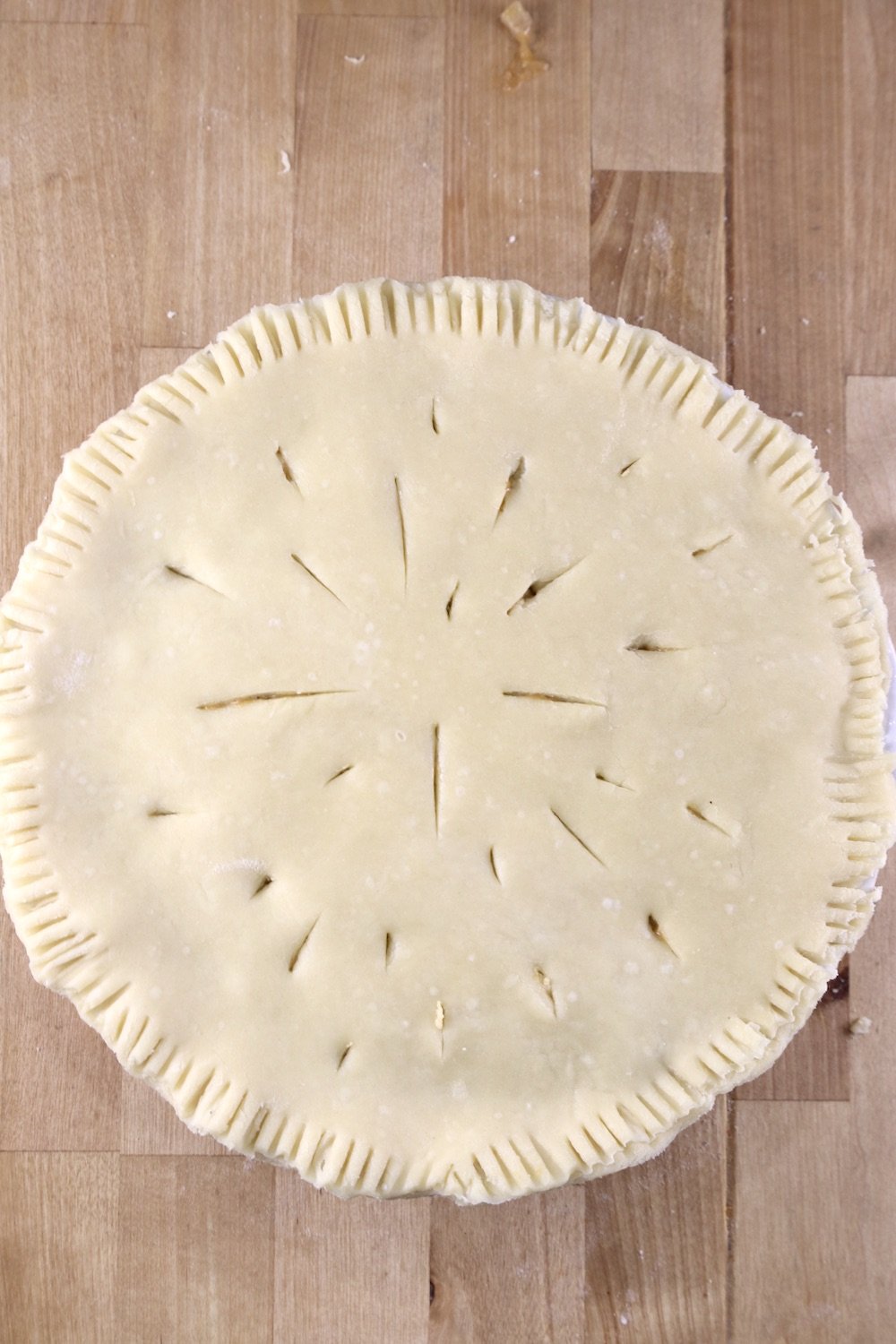Crawfish pie with slits cut into top in a random pattern