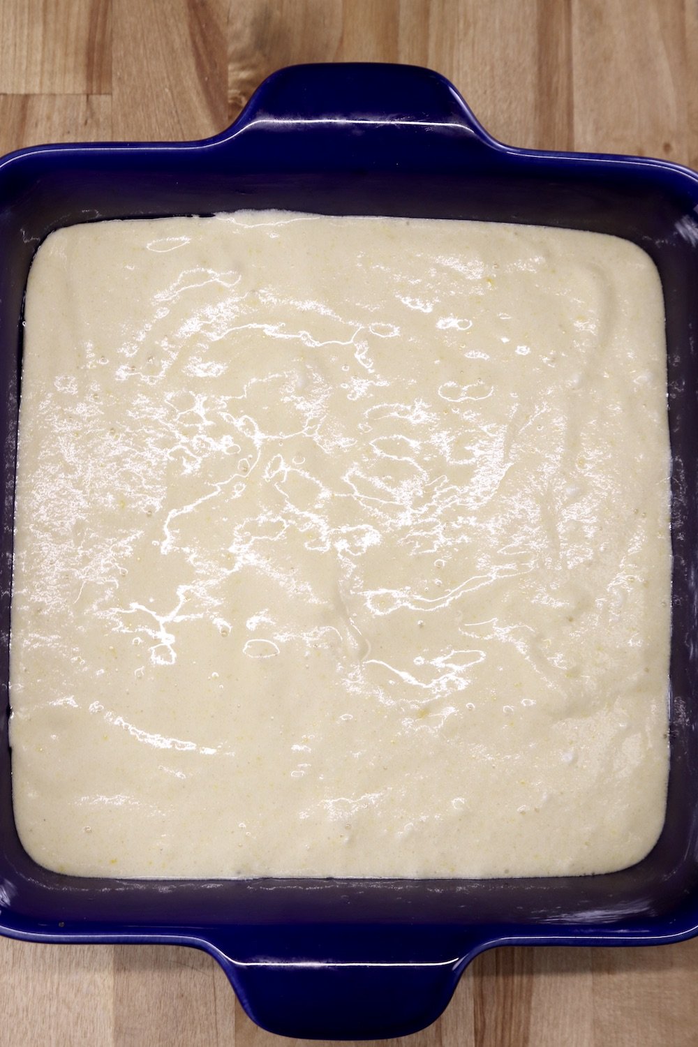square baking dish filled with pineapple upside down cake batter