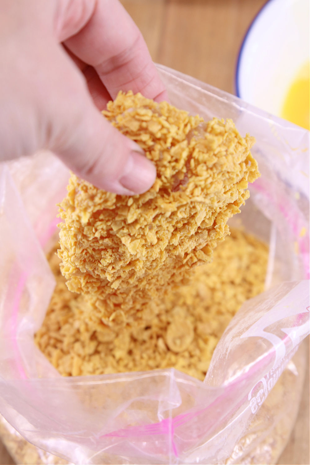 coating chicken in cornflake crumbs