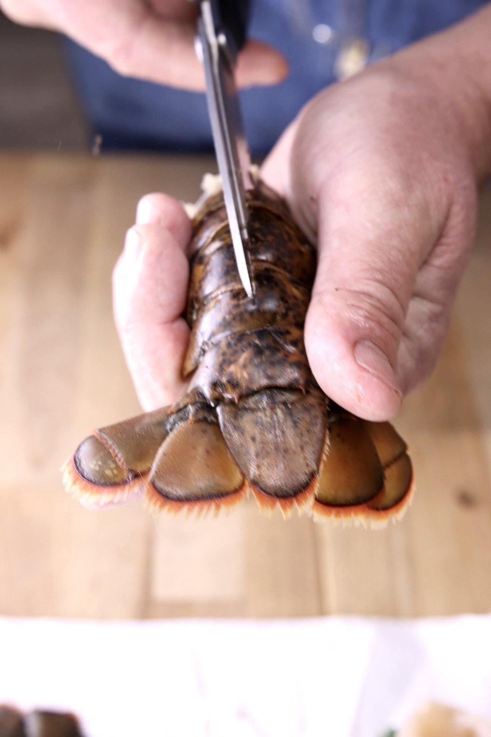 Cutting a lobster tail with kitchen shears