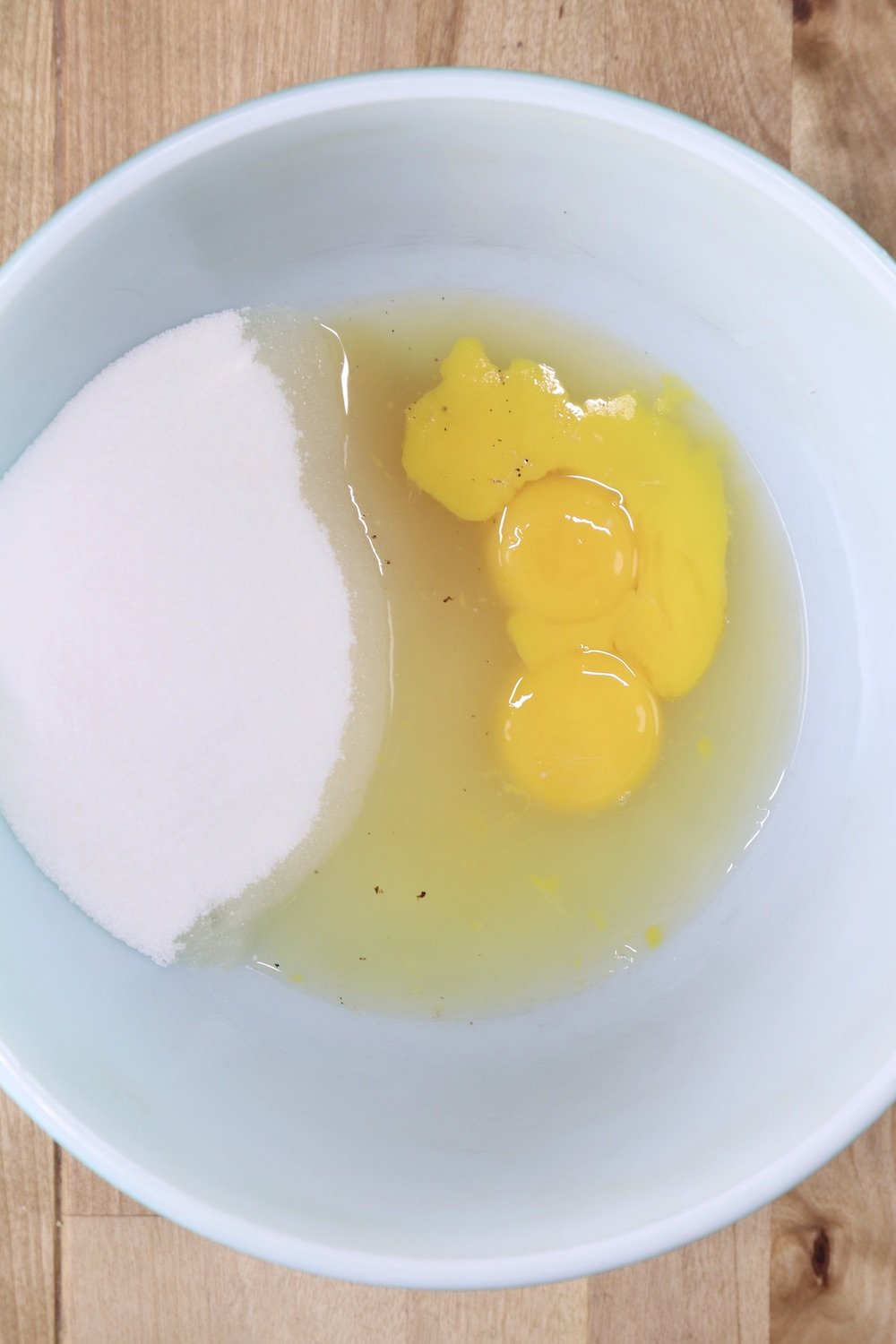 Bowl with sugar, eggs, pineapple juice and vanilla