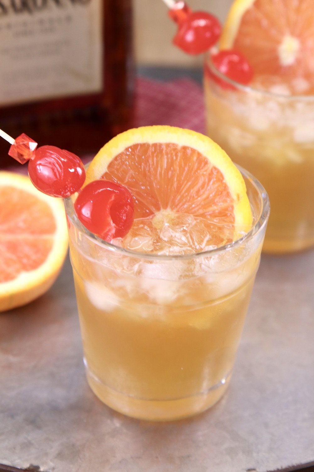 Amaretto Sour Cocktail with cherry and orange slice garnish