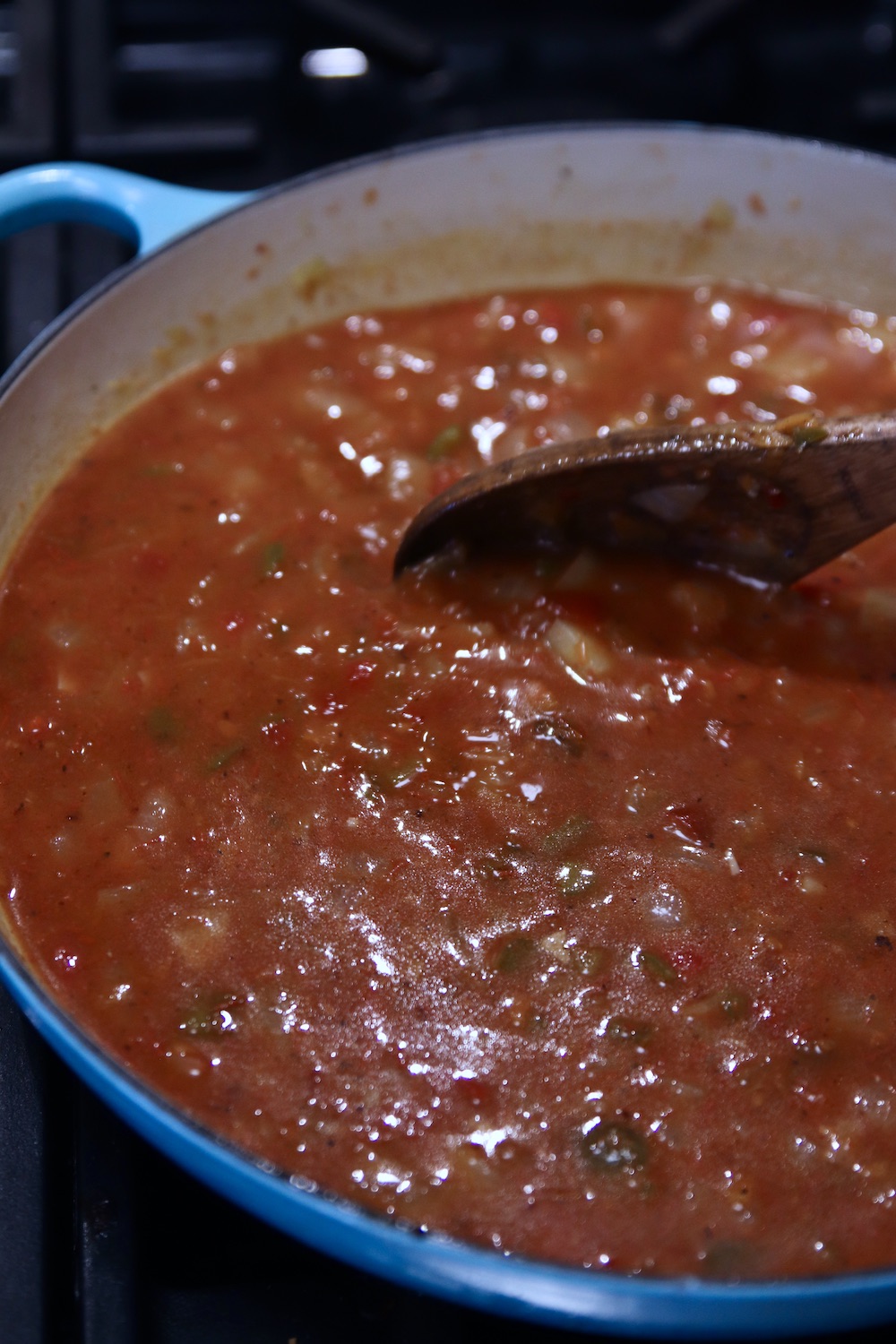 tomato sauce and broth added to vegetables for soup