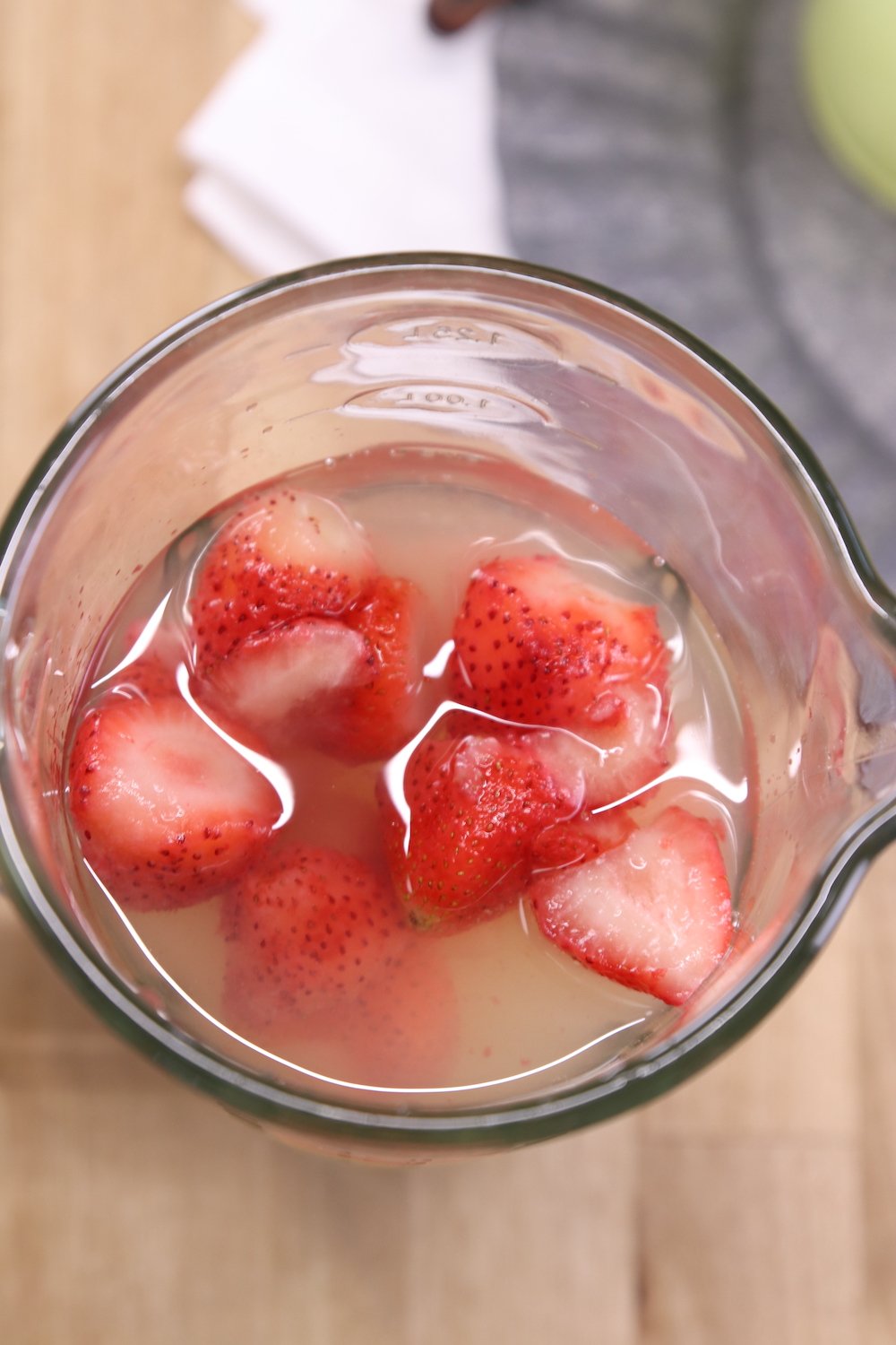blender with lemonade and frozen strawberries
