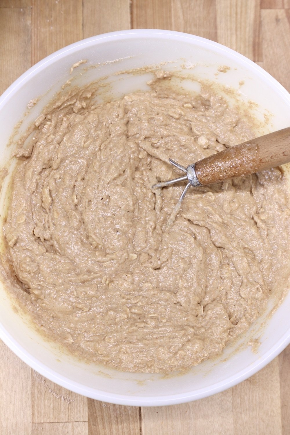 Irish Brown Bread dough in a bowl with a dough whisk