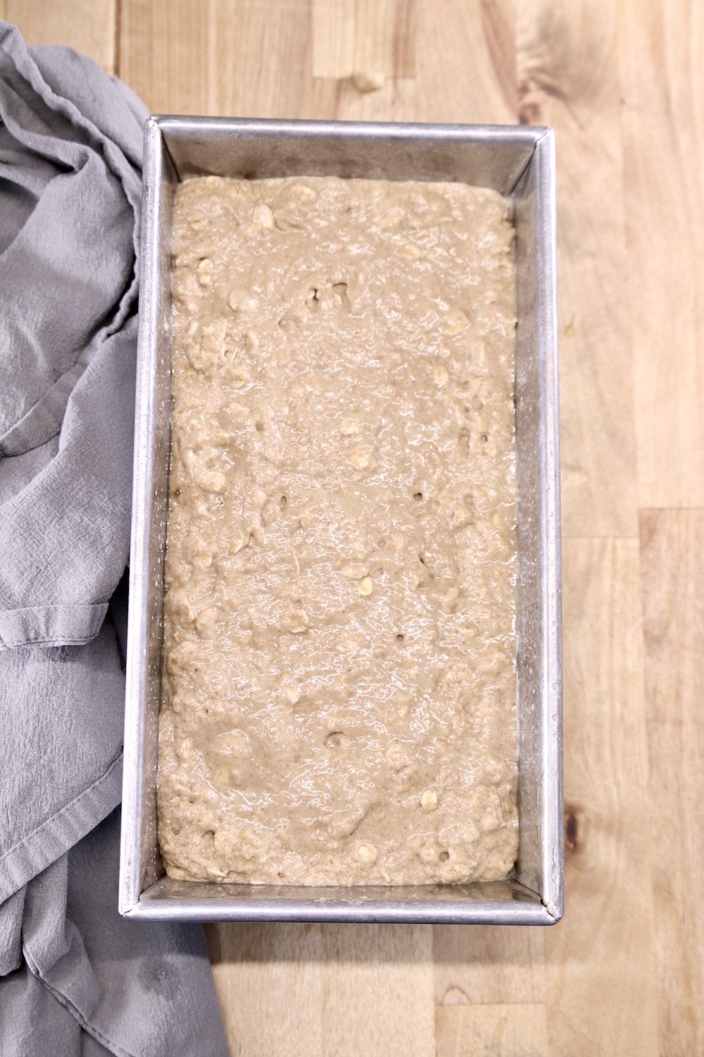 Loaf pan with brown bread batter