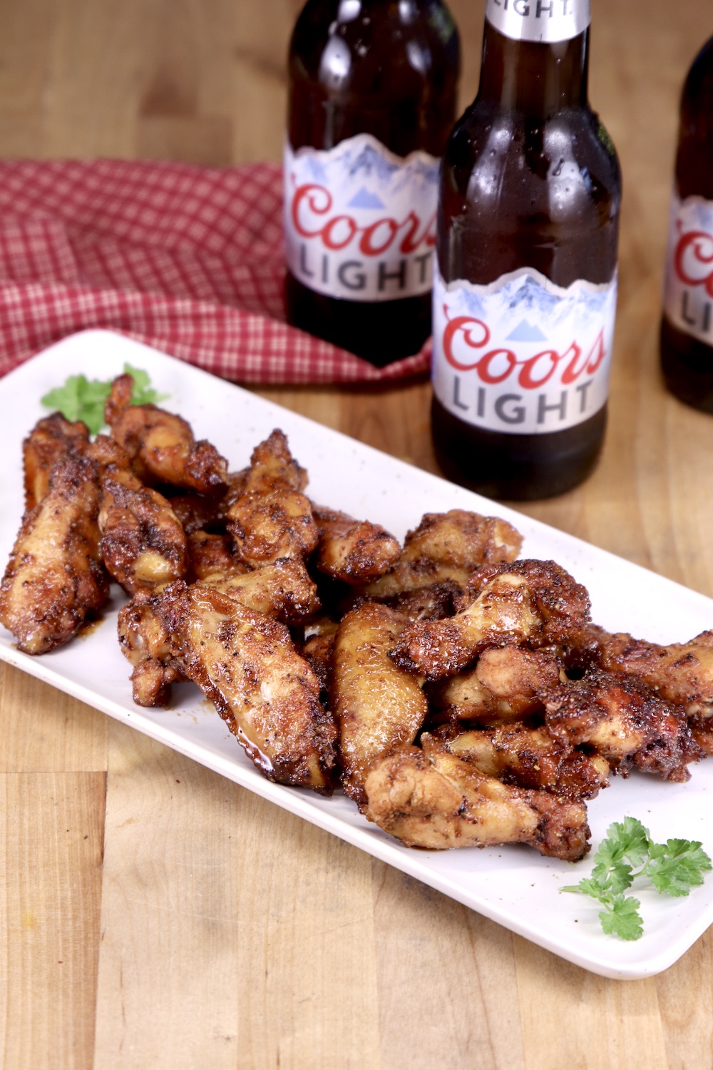 Maple Glazed Chicken Wings on a platter with 3 Coors light beer bottles