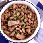 Bowl of pinto beans with chunks of ham