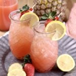 2 pineapple shaped glasses filled with pineapple strawberry lemonade cocktail