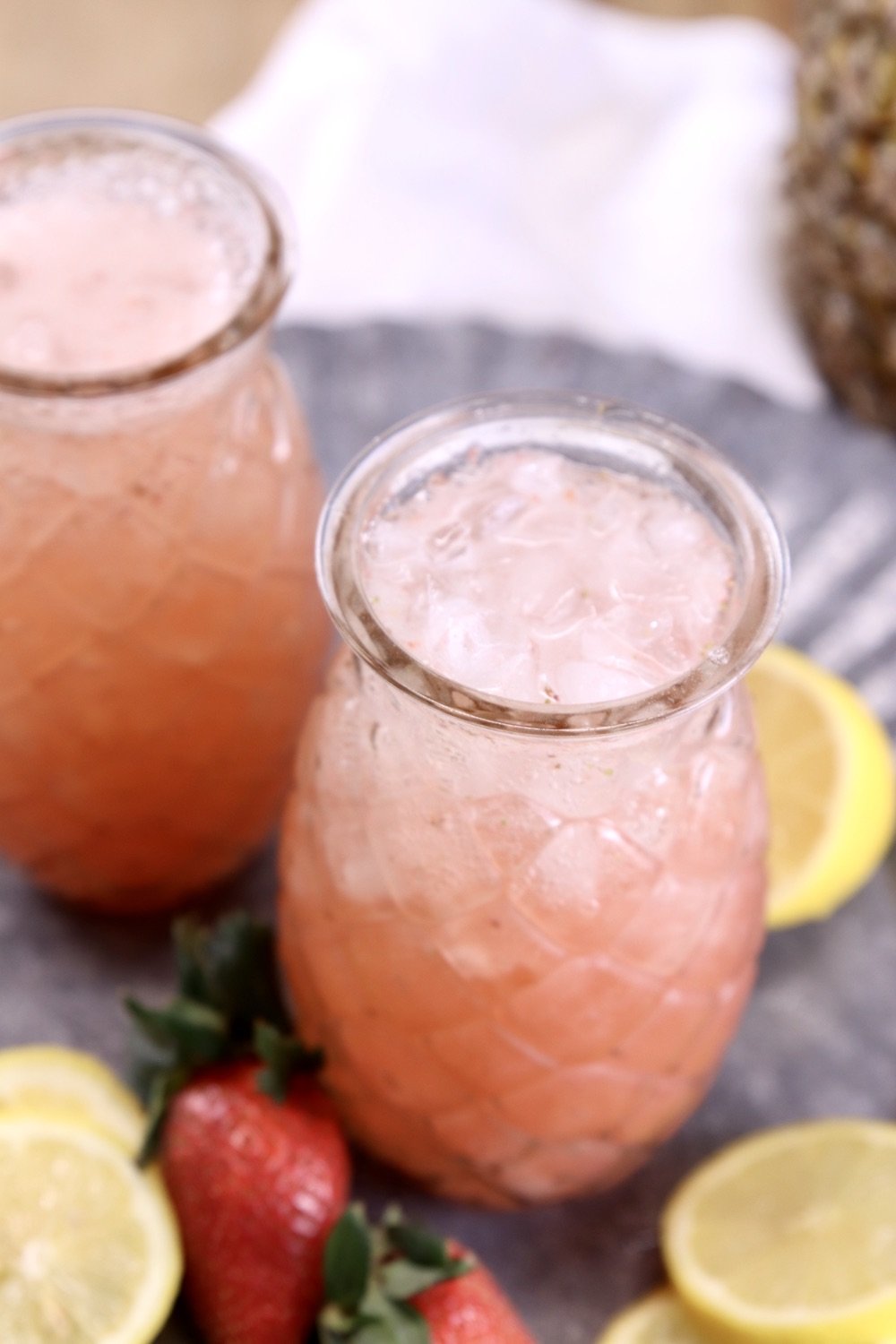 pineapple shaped glasses with strawberry lemonade cocktail