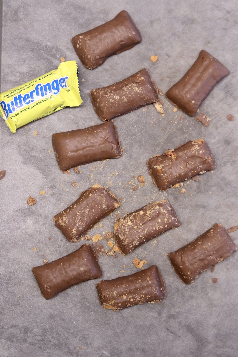 Unwrapped Butterfinger fun size candy bars, one wrapped