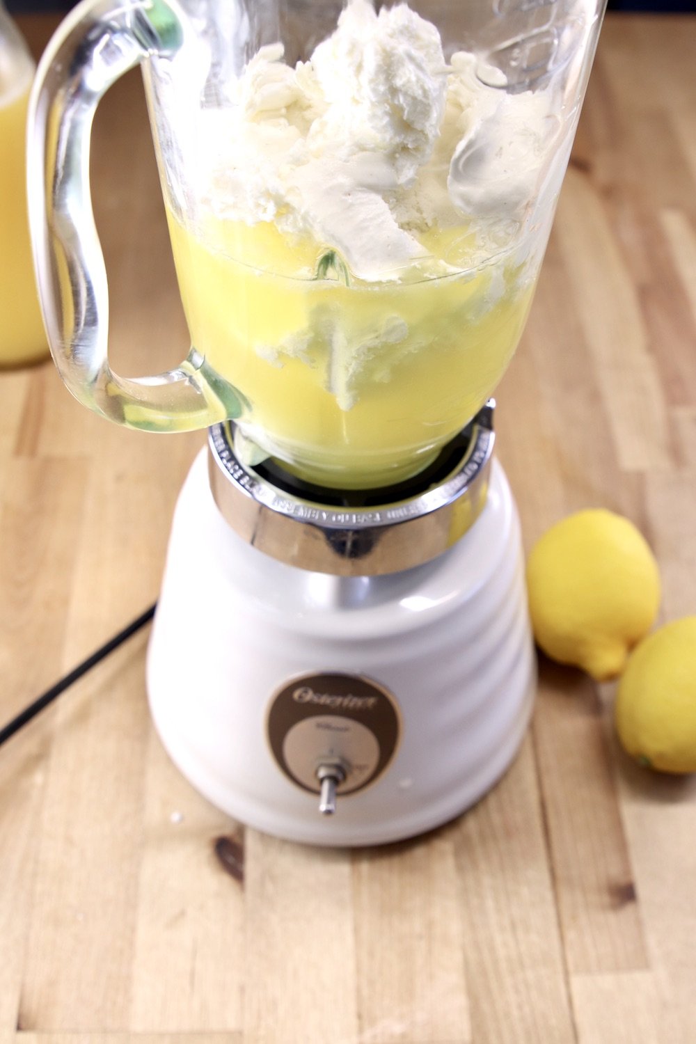 blender with pineapple juice and ice cream