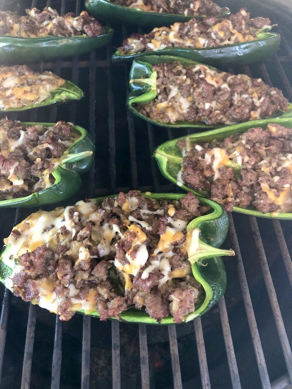 Grilled stuffed poblano peppers on a grill