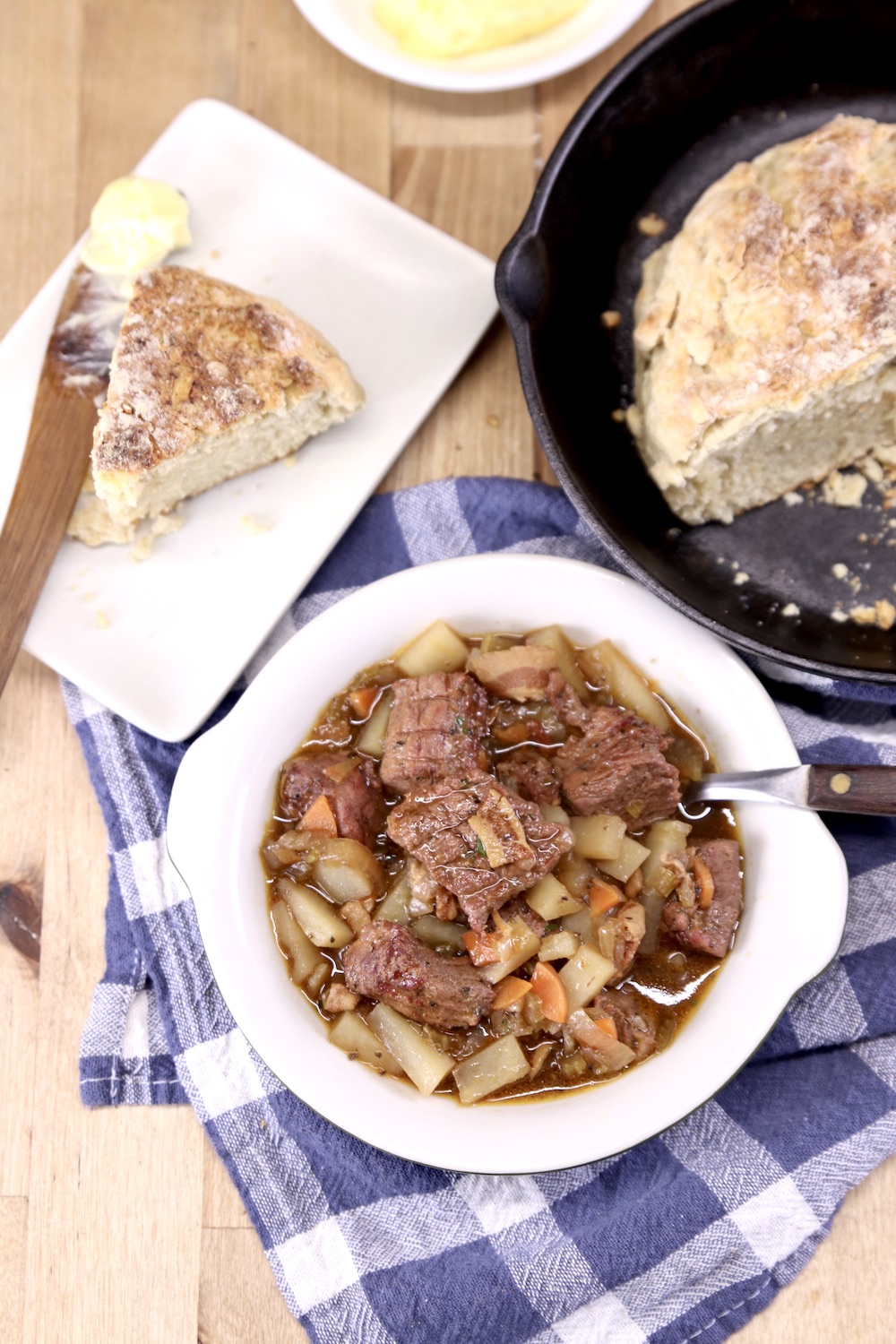 Irish stew with soda bread on a plate and skillet