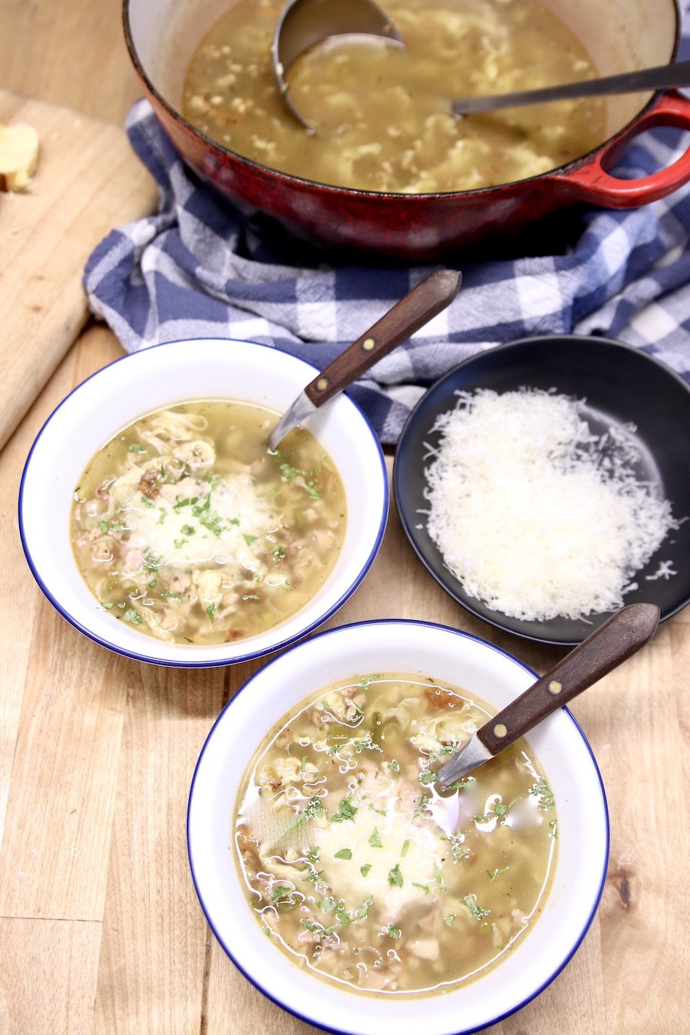 Stracciatella Soup with parmesan cheese, 2 bowls, soup pan and bowl of cheese