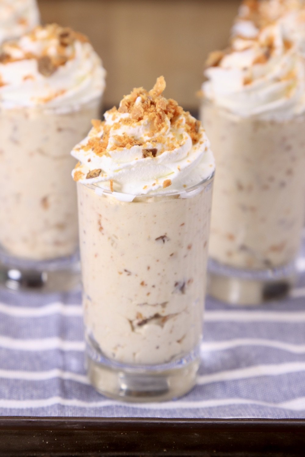 Small glasses of no bake Butterfinger Cheesecake