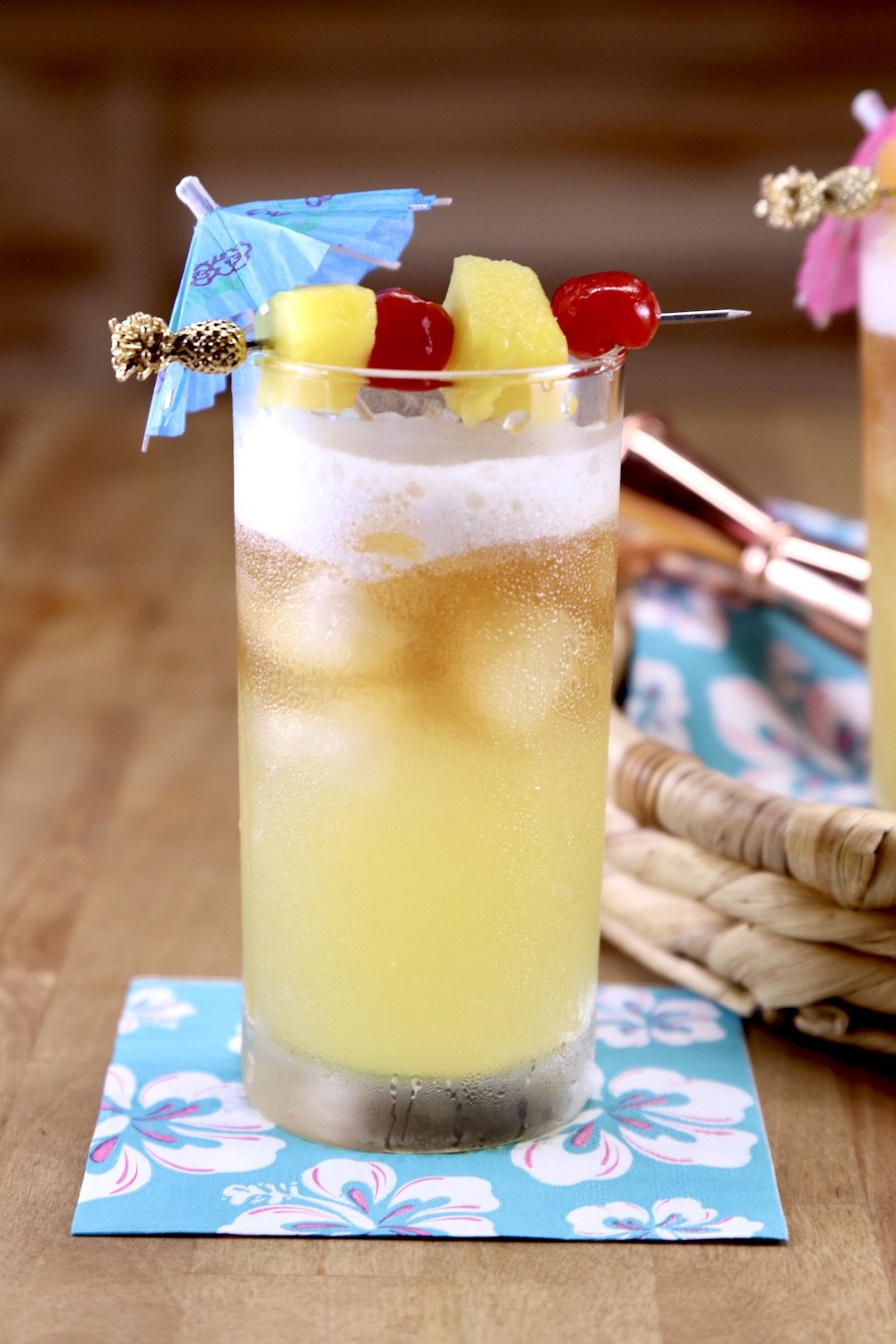 Pineapple Mai Tai drink with pineapple and cherry garnish